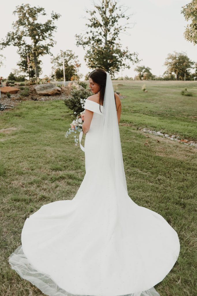 Bride with Bella Rosa Venue's north lawn in the background near Tulsa, OK